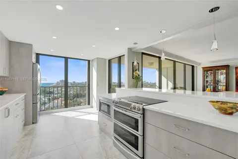 a kitchen with stainless steel appliances a refrigerator and countertop cabinets