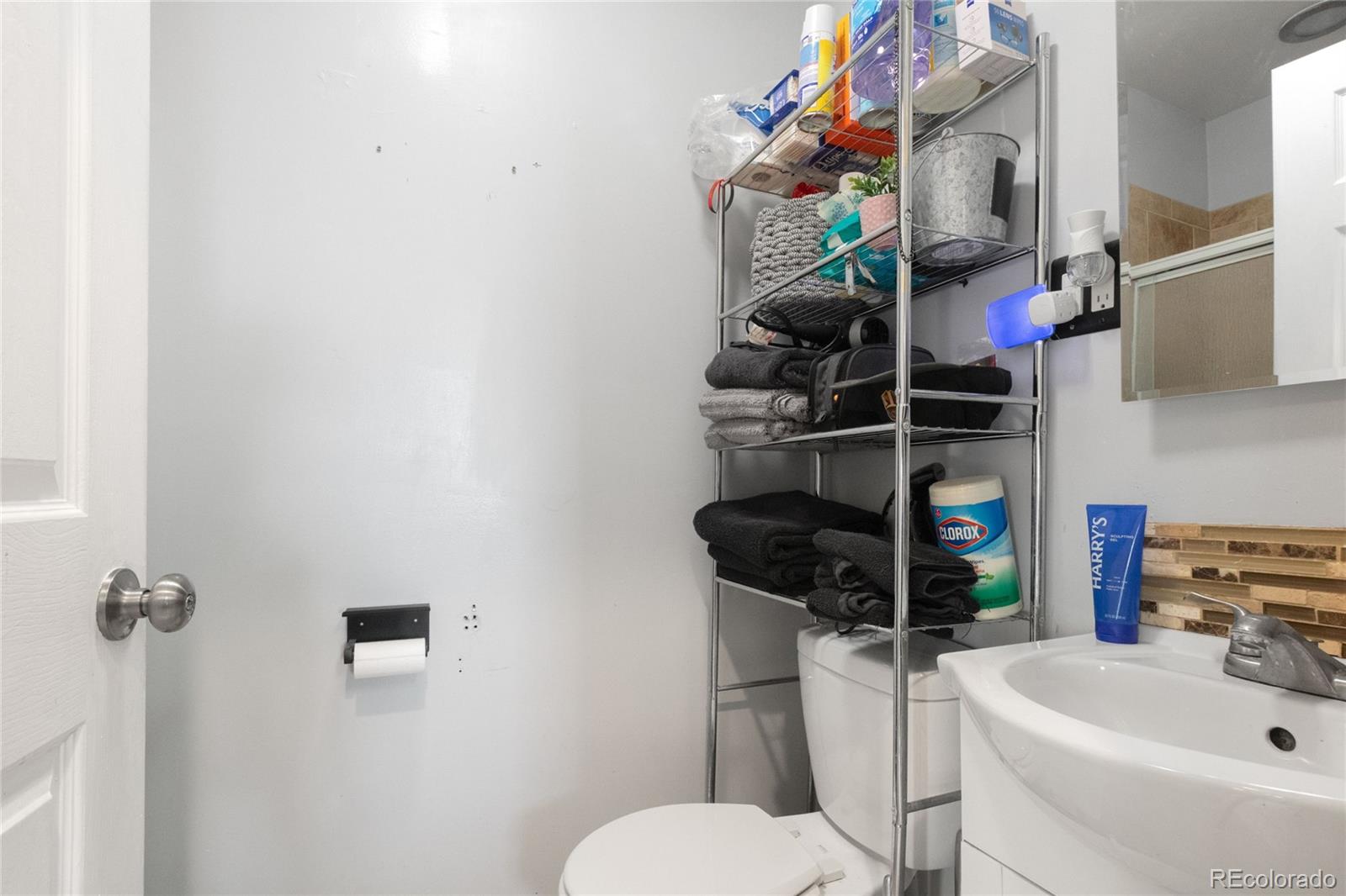 229 4th Street Fort Lupton, CO 80621 - Photo 11 of 25 a bathroom with a sink a toilet and shower