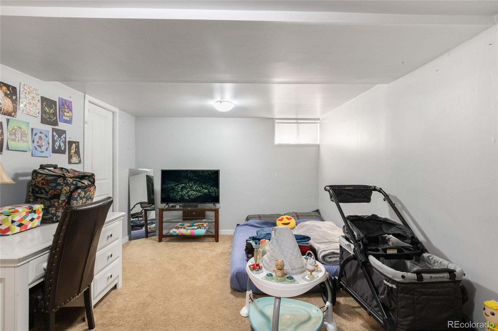 229 4th Street Fort Lupton, CO 80621 - Photo 15 of 25 a bedroom with furniture and a gym equipment