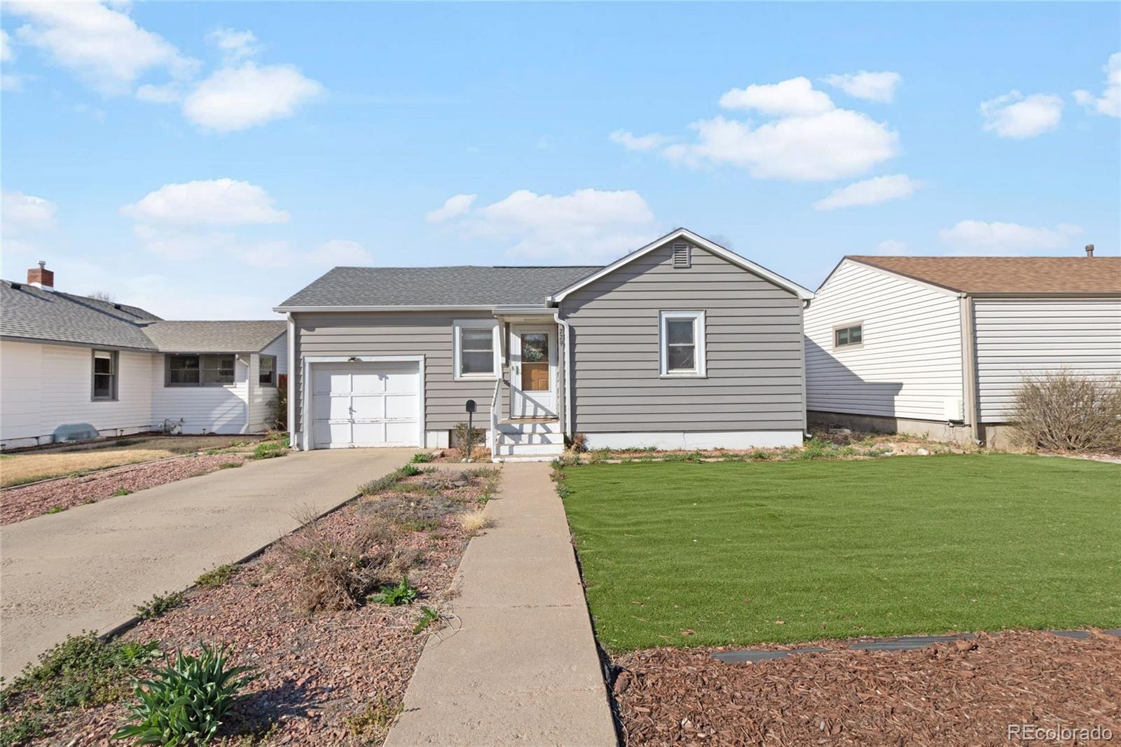 229 4th Street Fort Lupton, CO 80621 - Photo 2 of 25 a front view of a house with a garden