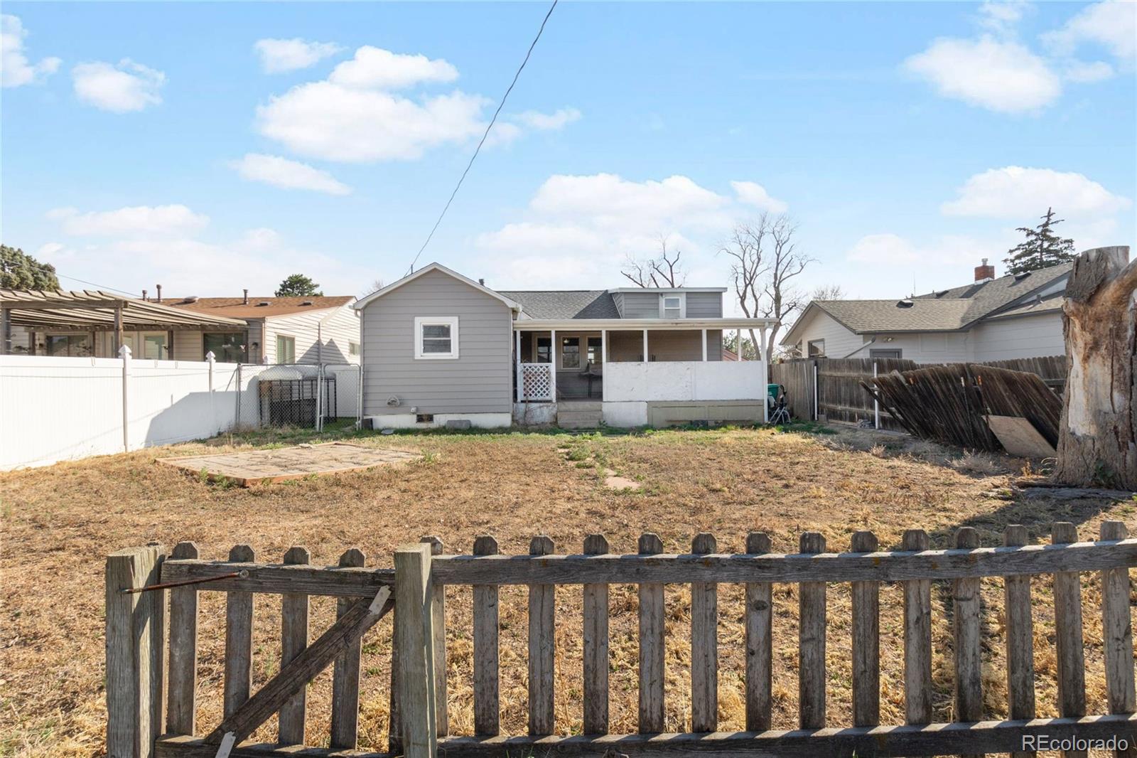 229 4th Street Fort Lupton, CO 80621 - Photo 25 of 25 a view of a house with a wooden fence