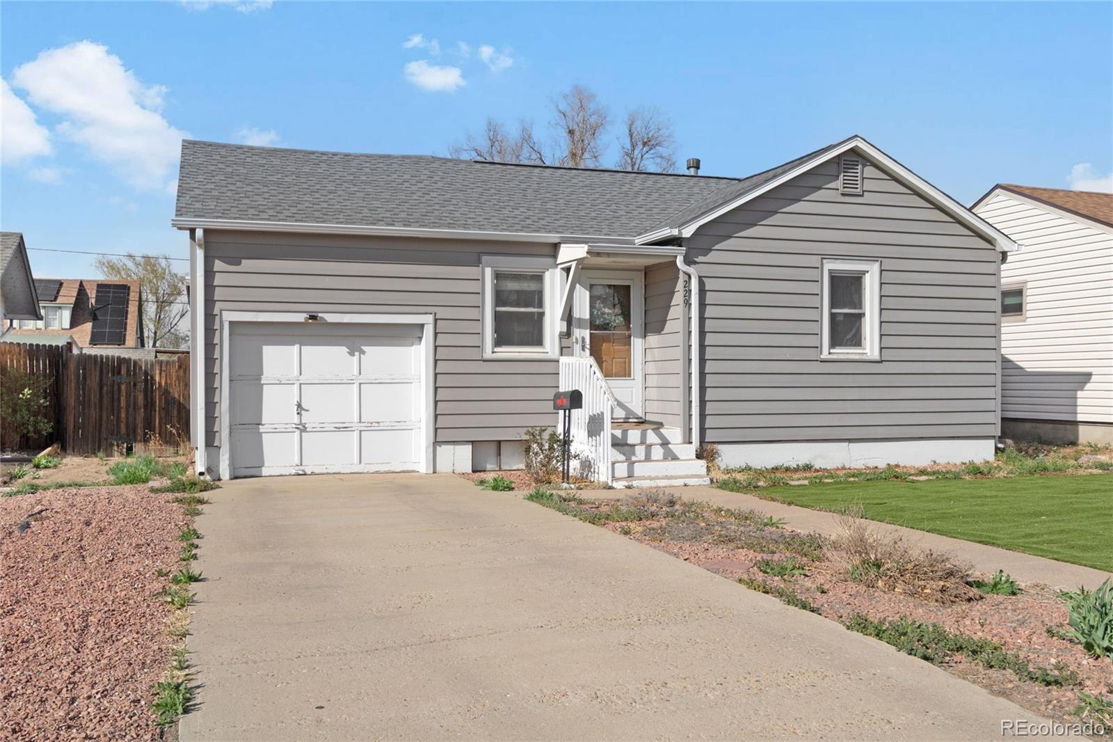 229 4th Street Fort Lupton, CO 80621 - Photo 3 of 25 a front view of a house with a yard