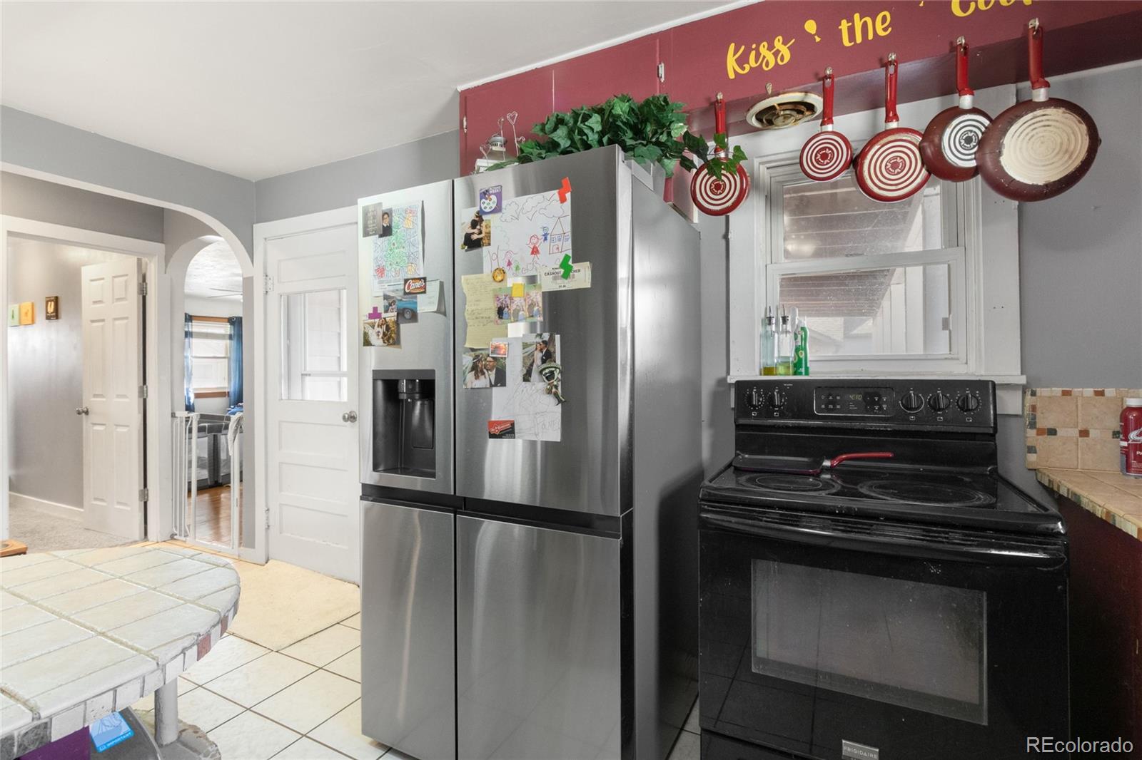 229 4th Street Fort Lupton, CO 80621 - Photo 6 of 25 a kitchen with stainless steel appliances granite countertop a refrigerator and a stove