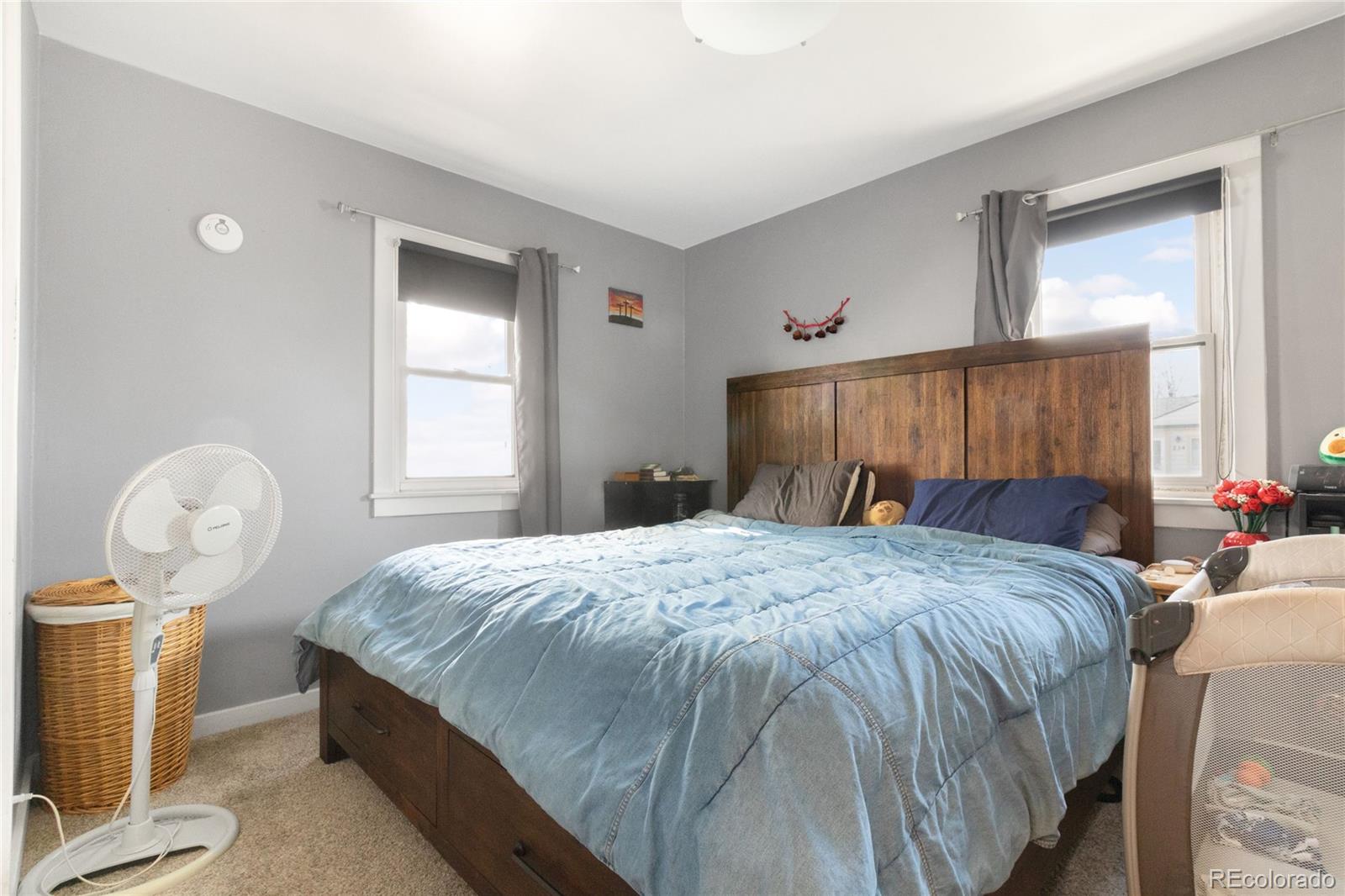 229 4th Street Fort Lupton, CO 80621 - Photo 9 of 25 a bedroom with a bed and dresser