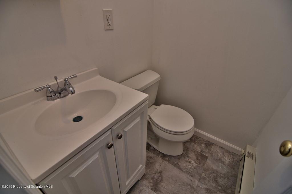 3585 Hornbaker Cemetary Road Moscow, PA 18444 - Photo 7 of 46 a white toilet sitting next to a bathroom sink
