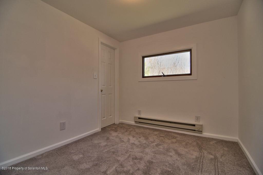 3585 Hornbaker Cemetary Road Moscow, PA 18444 - Photo 8 of 46 an empty room with a bench