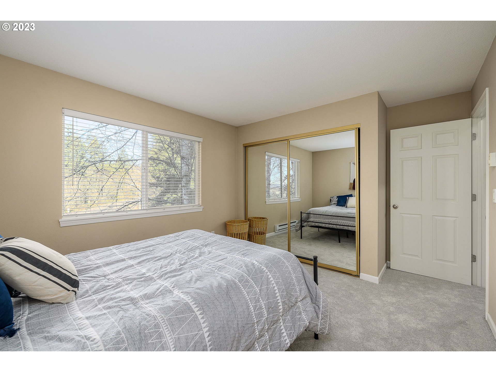 10178 Southeast Talbert Street Clackamas, OR 97015 - Photo 19 of 32 a spacious bedroom with a bed and a window
