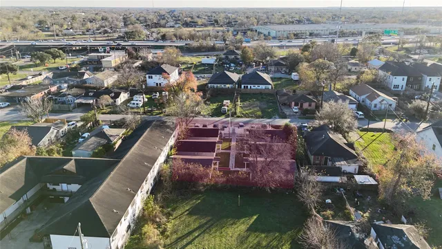 an aerial view of a house with a garden and lake view