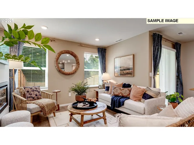 a living room with furniture a clock potted plant and a window