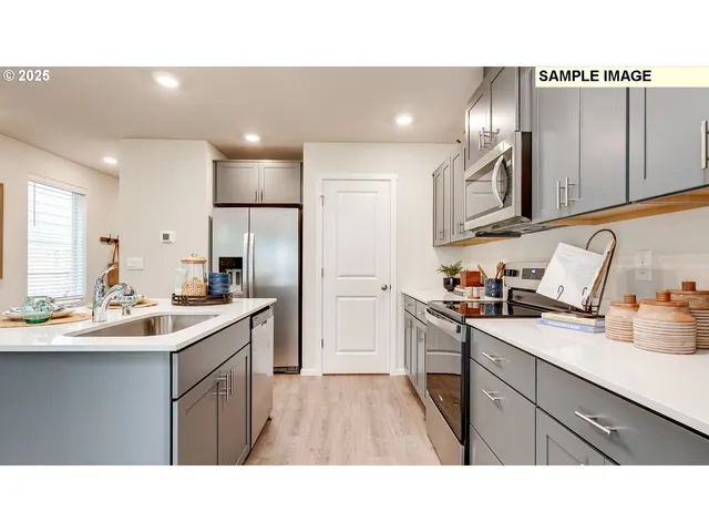 a kitchen with a sink stainless steel appliances and cabinets