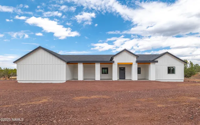 a view of a house with a yard and garage
