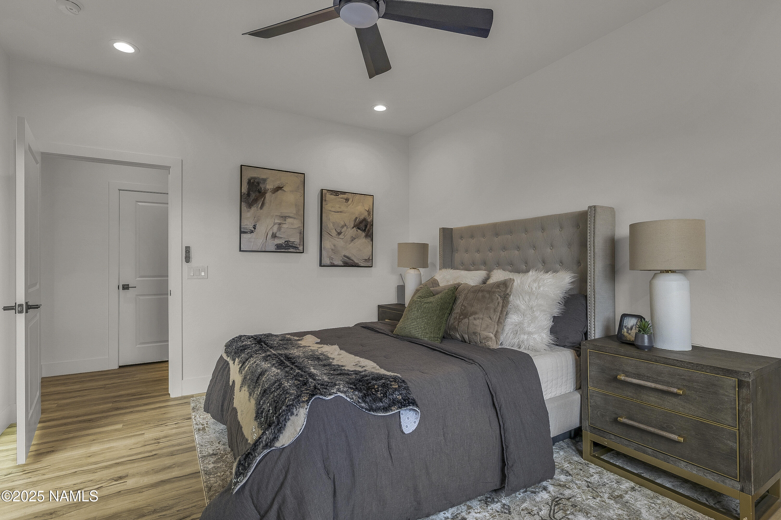 7935 North Red Lake Road Williams, AZ 86046 - Photo 14 of 31 a bedroom with a bed and wooden floor
