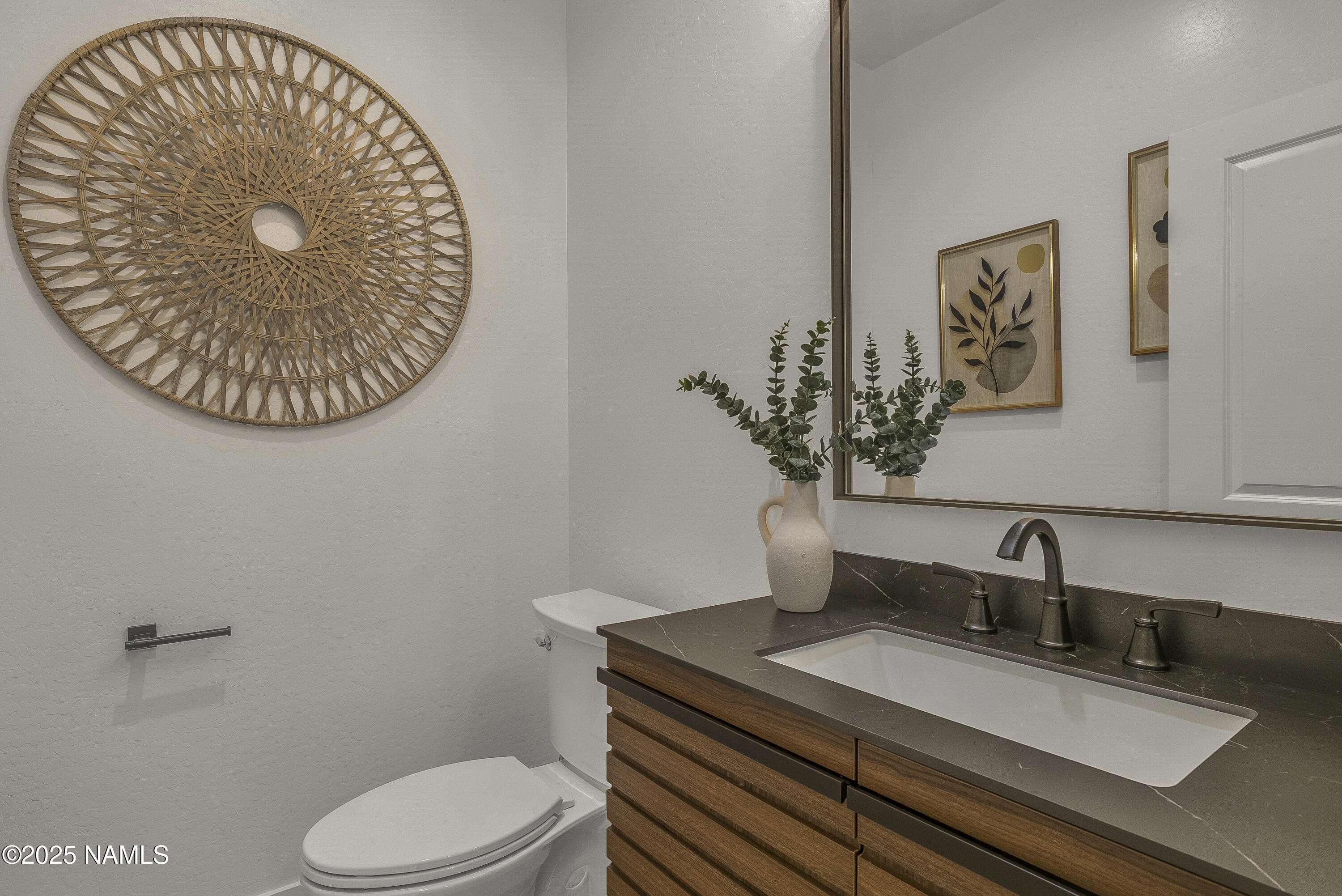 7935 North Red Lake Road Williams, AZ 86046 - Photo 18 of 31 a bathroom with a toilet sink and mirror