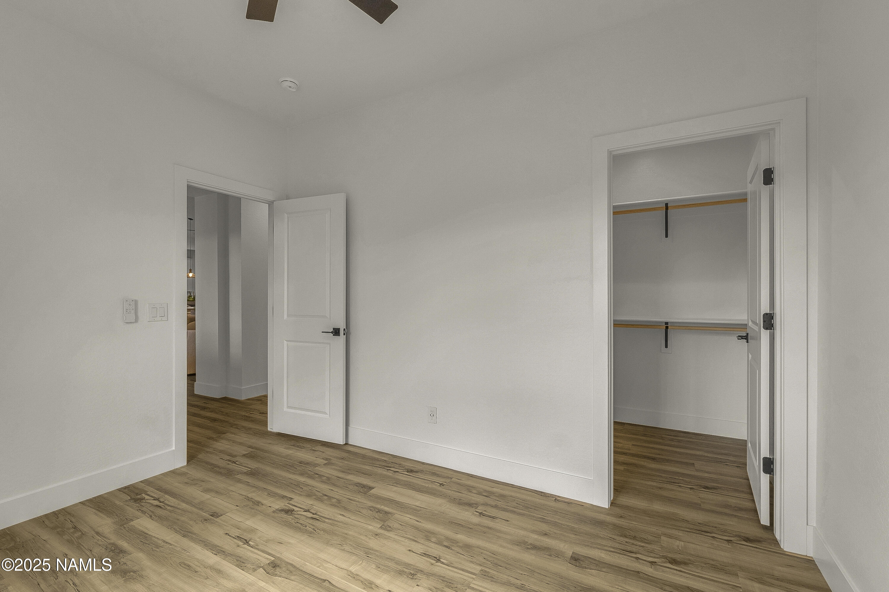 7935 North Red Lake Road Williams, AZ 86046 - Photo 19 of 31 a view of an empty room with wooden floor