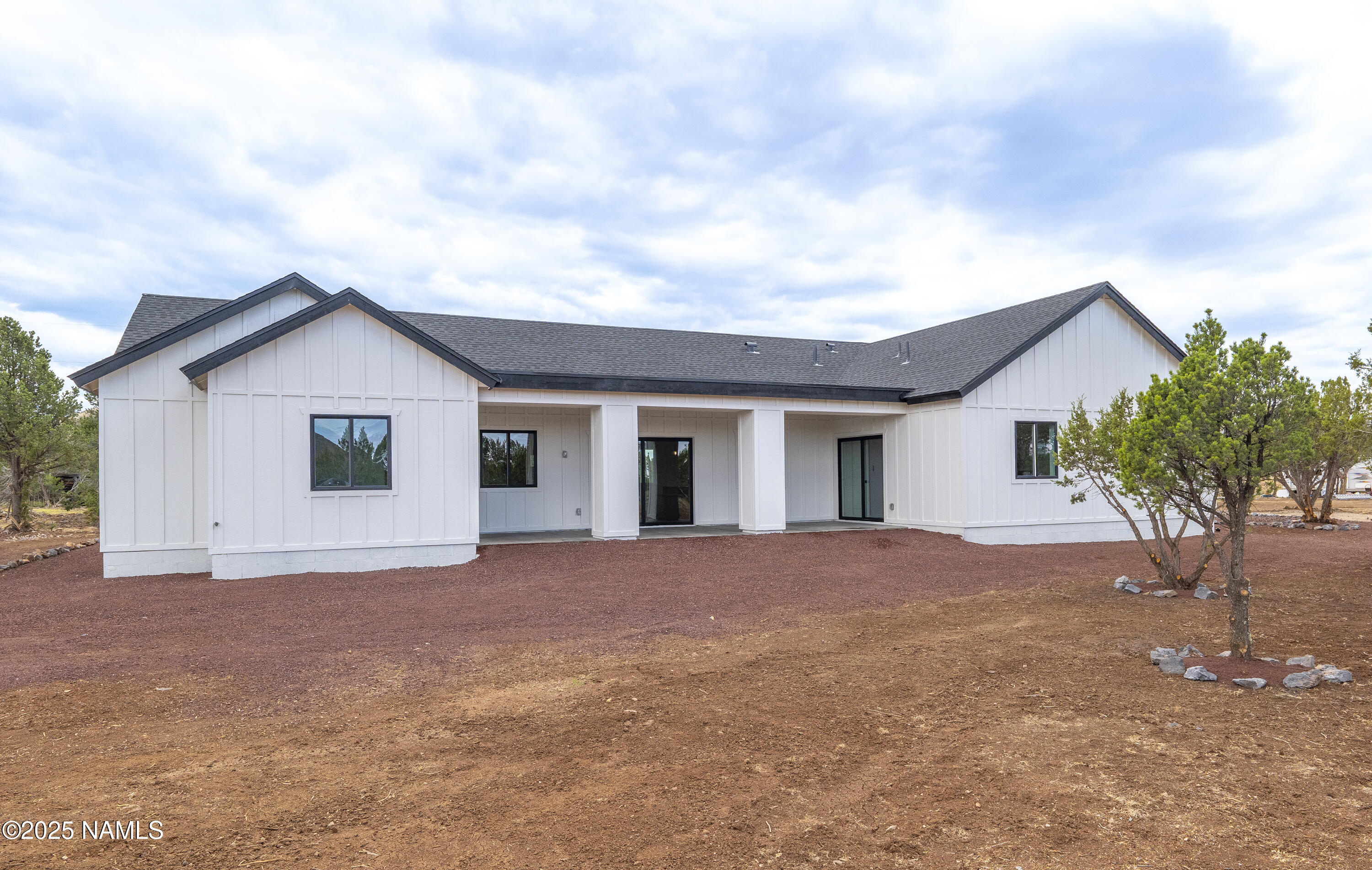 7935 North Red Lake Road Williams, AZ 86046 - Photo 24 of 31 a view of a house with a yard and garage