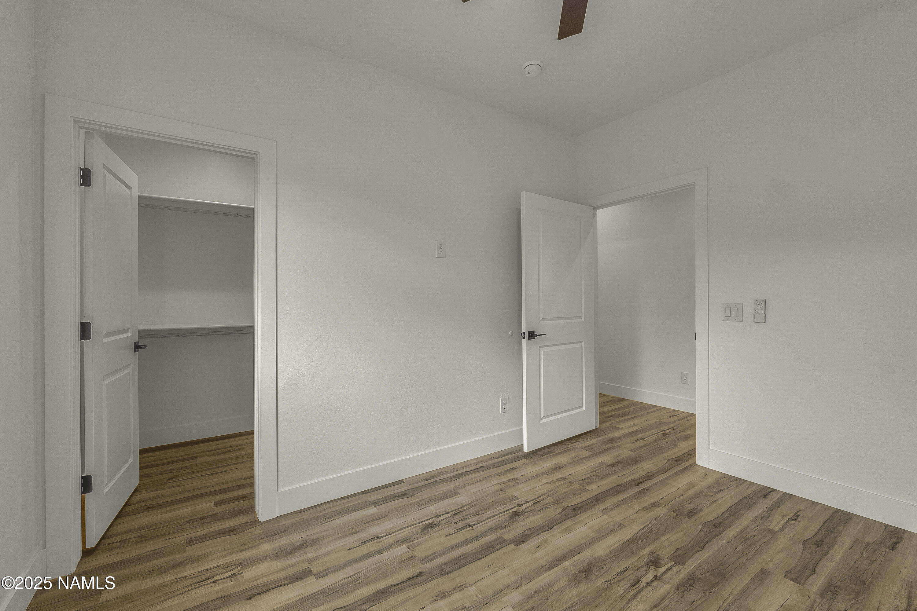 7935 North Red Lake Road Williams, AZ 86046 - Photo 25 of 31 a view of an empty room with wooden floor