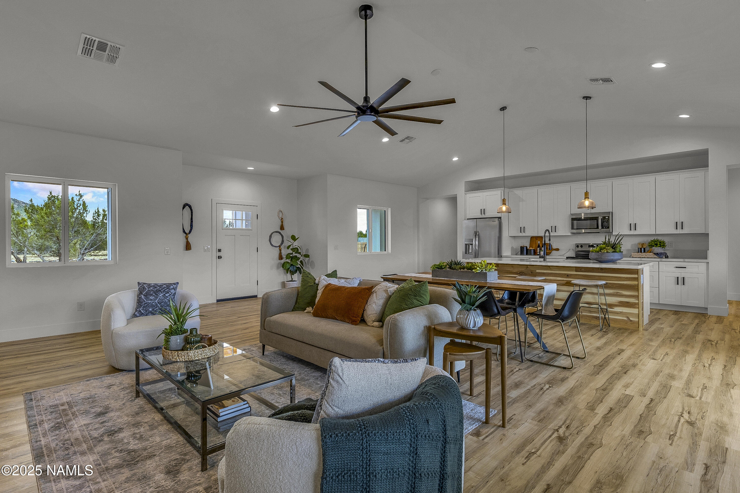 7935 North Red Lake Road Williams, AZ 86046 - Photo 3 of 31 a living room with furniture kitchen view and a wooden floor