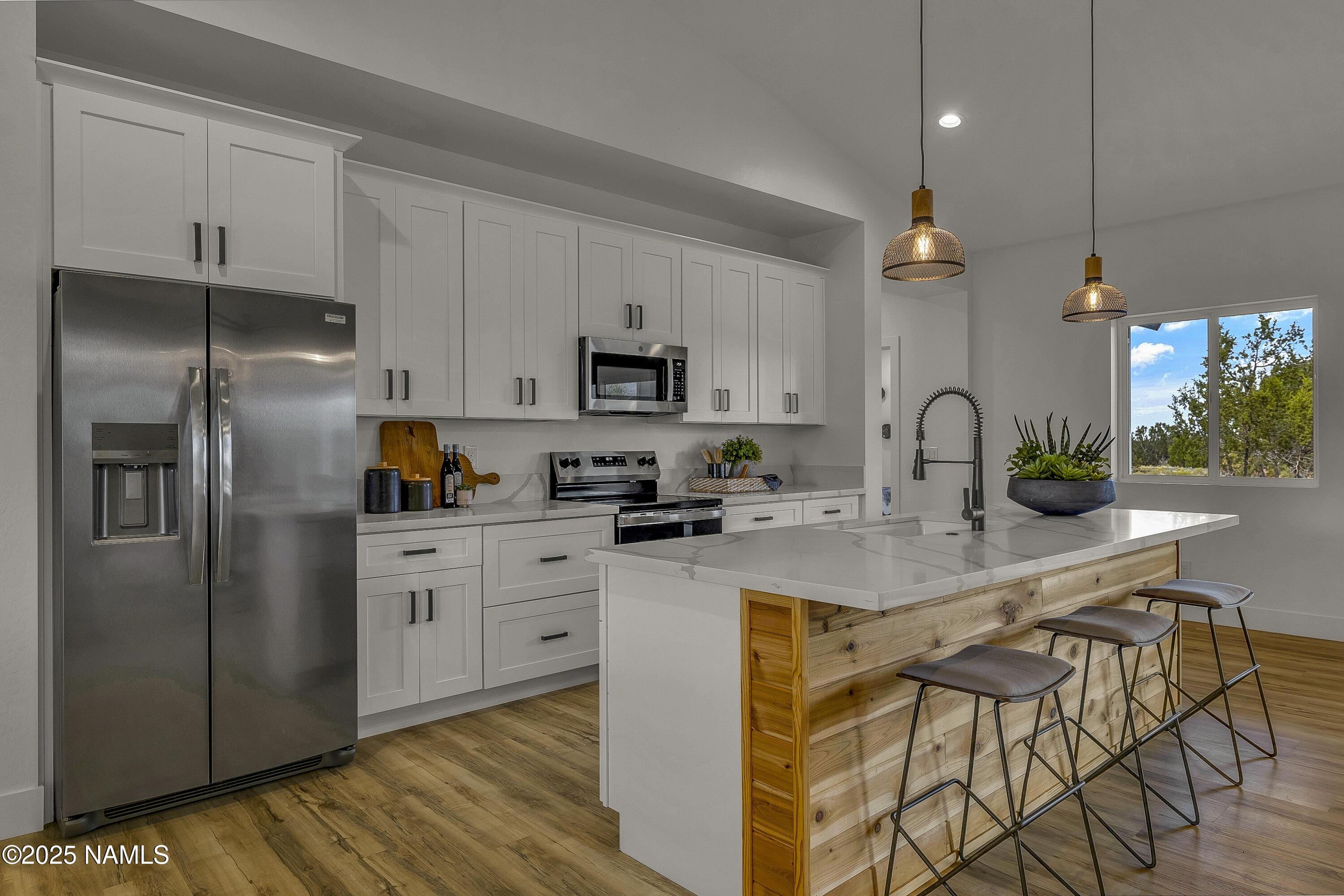 7935 North Red Lake Road Williams, AZ 86046 - Photo 5 of 31 a kitchen with stainless steel appliances granite countertop a refrigerator a sink dishwasher a stove and white cabinets with wooden floor