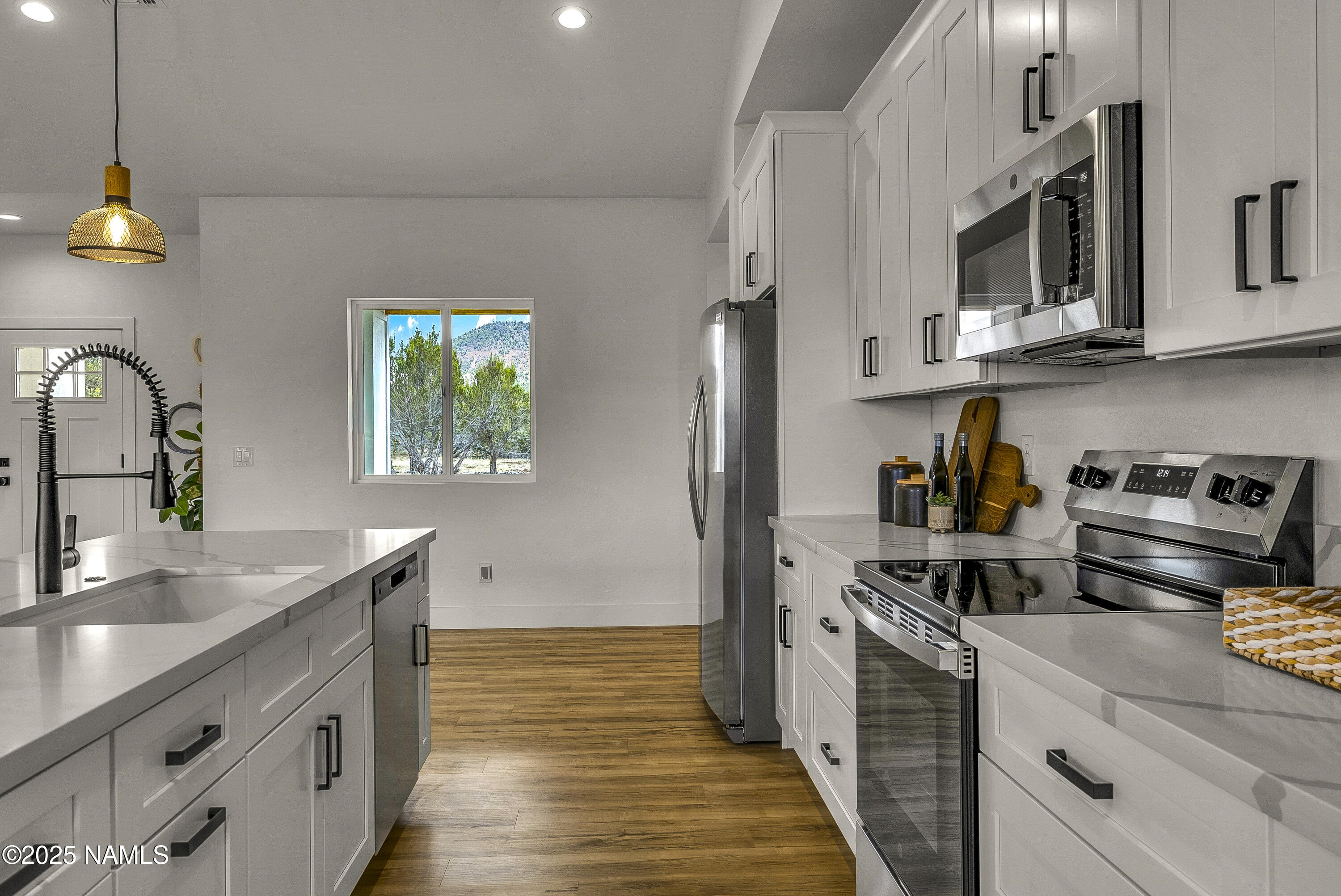 7935 North Red Lake Road Williams, AZ 86046 - Photo 6 of 31 a kitchen with stainless steel appliances granite countertop a sink stove and refrigerator