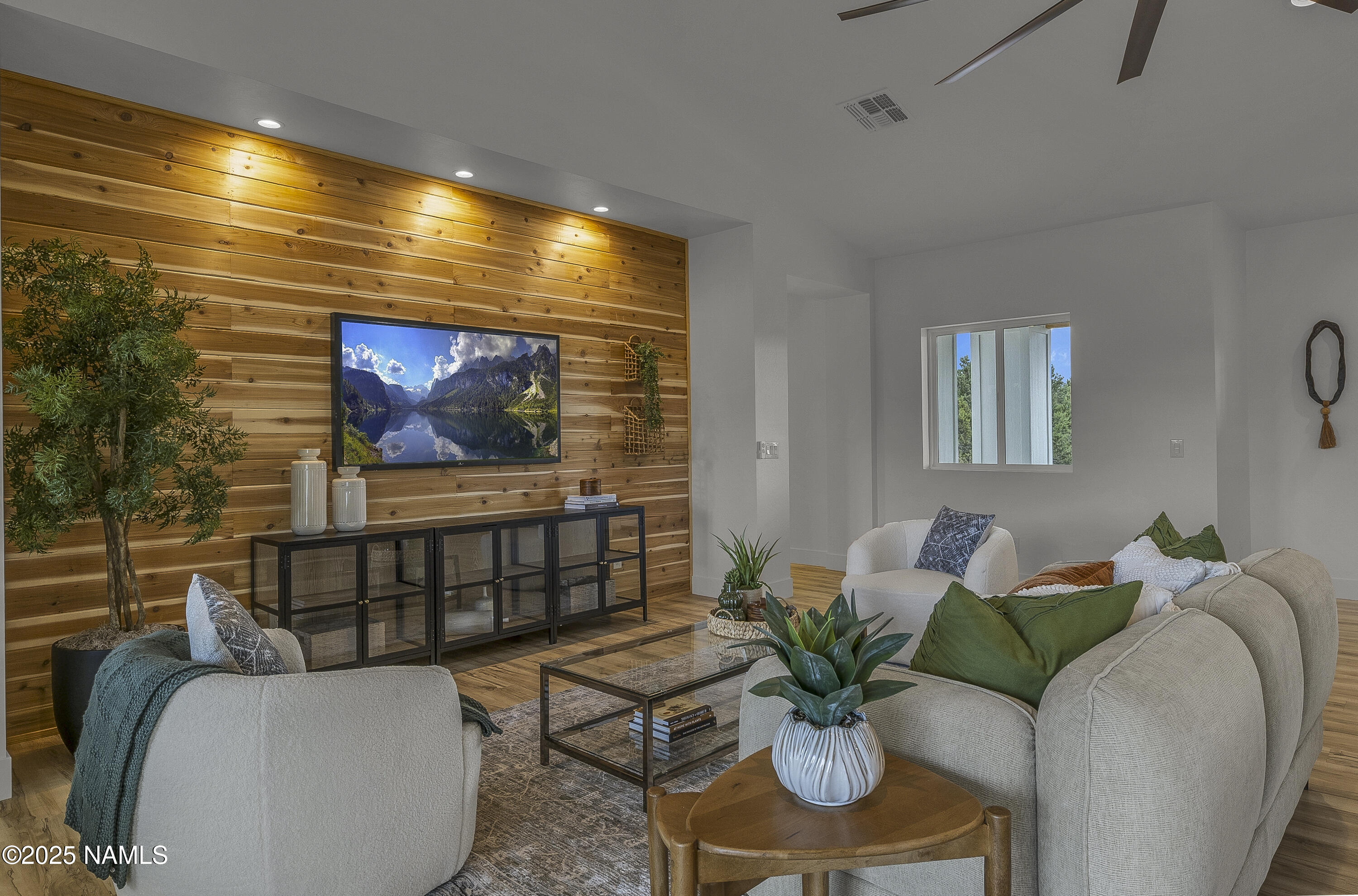 7935 North Red Lake Road Williams, AZ 86046 - Photo 7 of 31 a living room with furniture a flat screen tv and a potted plant