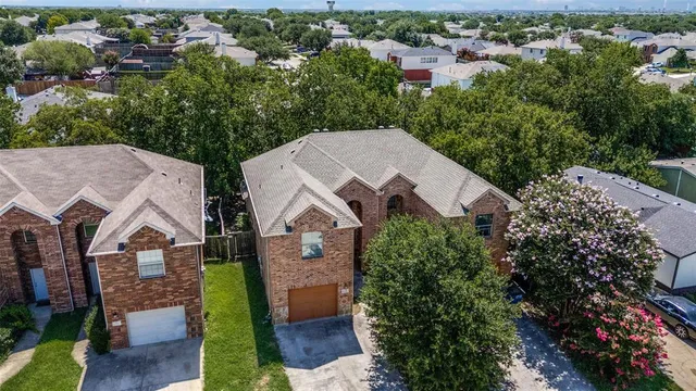 an aerial view of a house with a yard and lake view