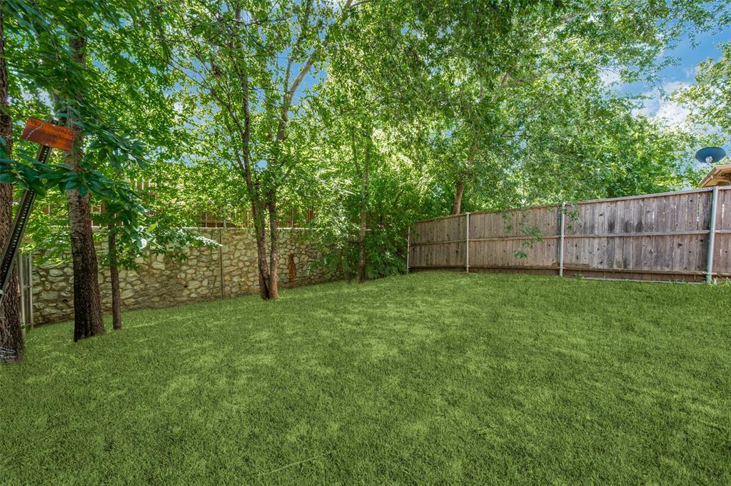 430 Woodgrove Drive, Unit A & B Little Elm, TX 75068 - Photo 16 of 20 a view of a backyard with large trees and wooden fence