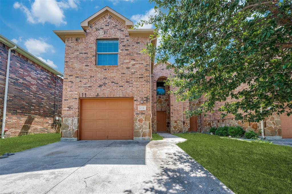 430 Woodgrove Drive, Unit A & B Little Elm, TX 75068 - Photo 5 of 20 a front view of a stone house with a yard