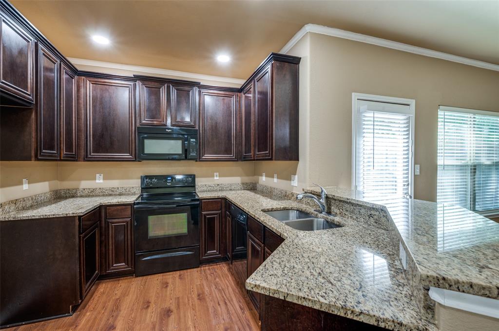 430 Woodgrove Drive, Unit A & B Little Elm, TX 75068 - Photo 8 of 20 a kitchen with granite countertop stainless steel appliances a sink stove and cabinets