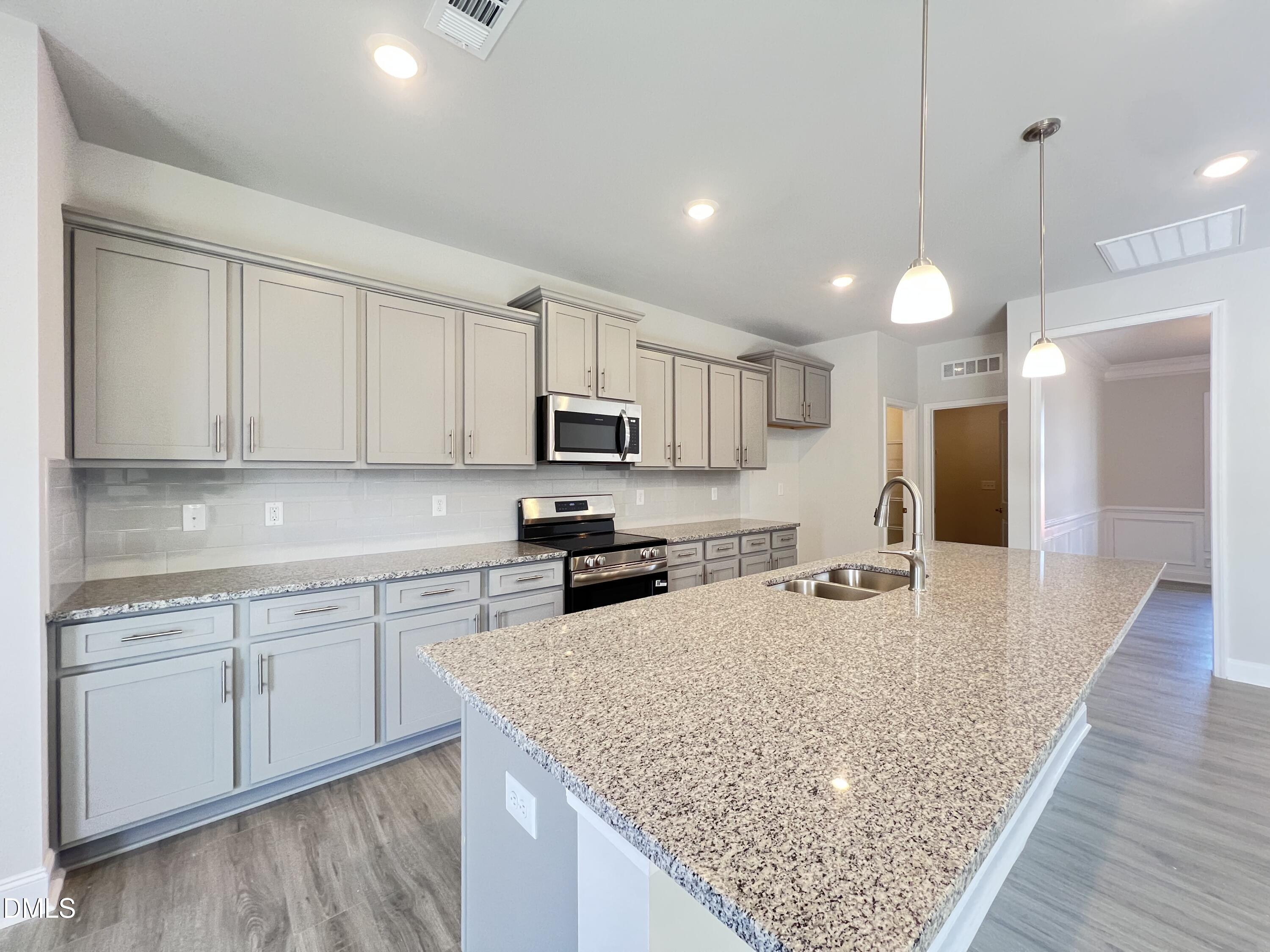 4009 Fletcher Road Bailey, NC 27807 - Photo 10 of 38 a kitchen with stainless steel appliances granite countertop a sink stove and refrigerator