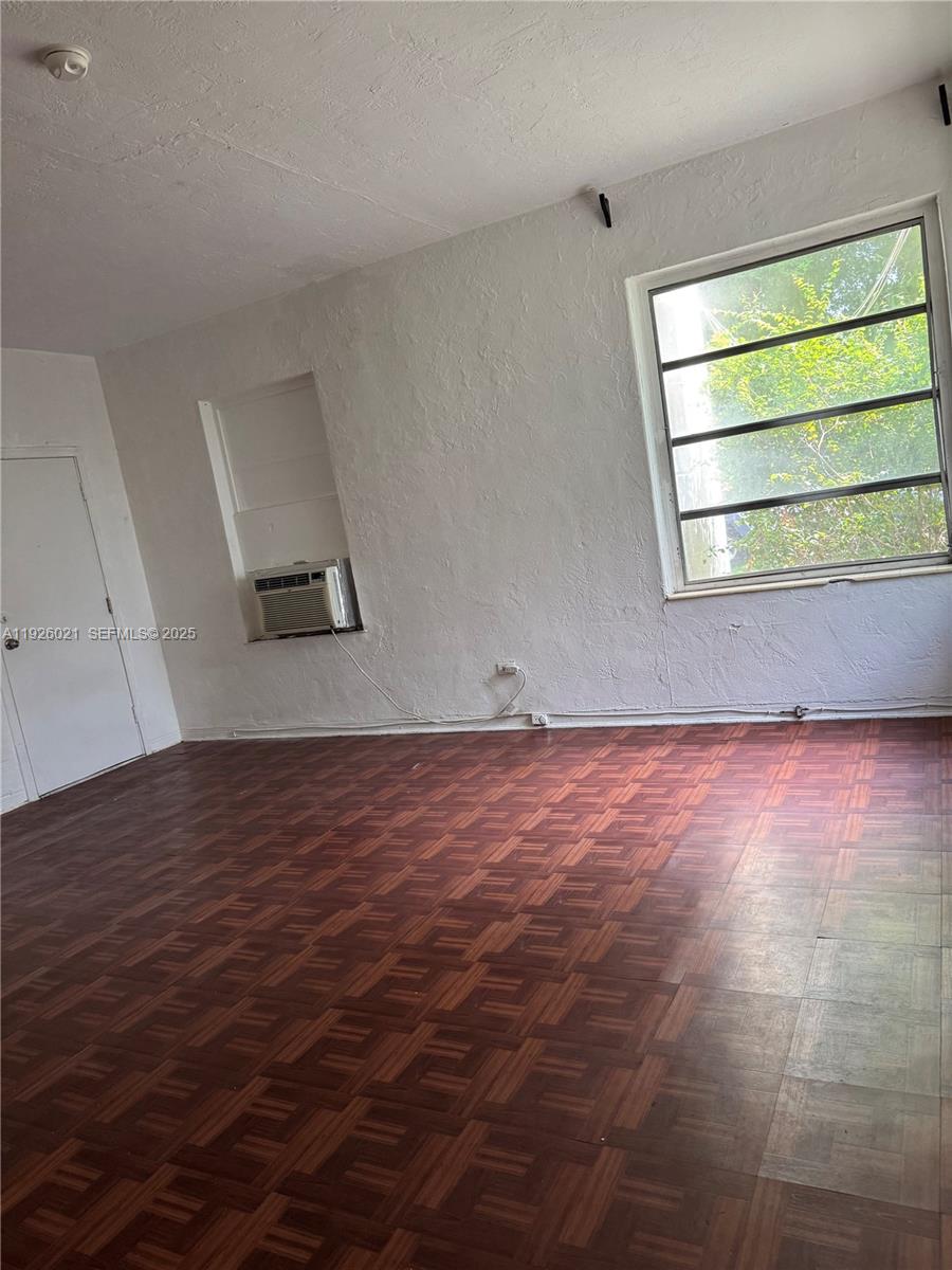 825 Alton Road, Unit 2 Miami Beach, FL 33139 - Photo 2 of 7 an empty room with a empty space and wooden floor