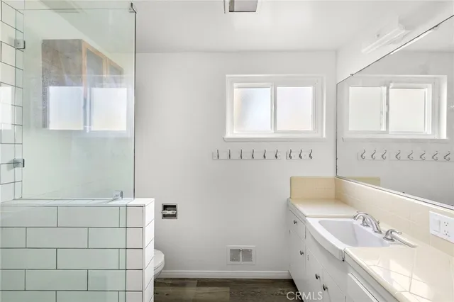 a bathroom with a tub a sink and a window