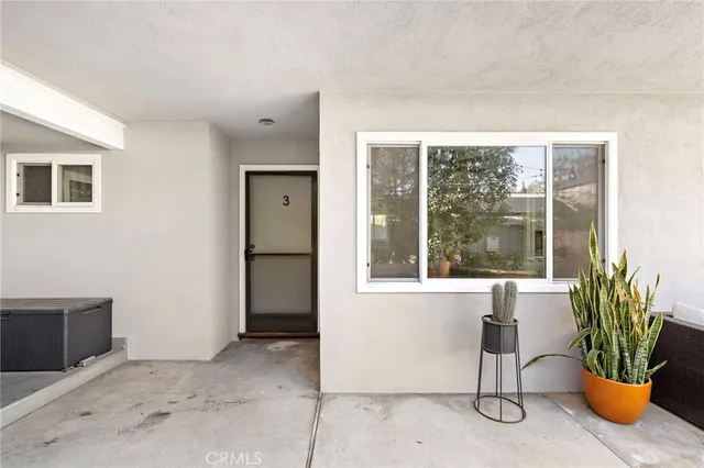 a view of a room with a window and chair