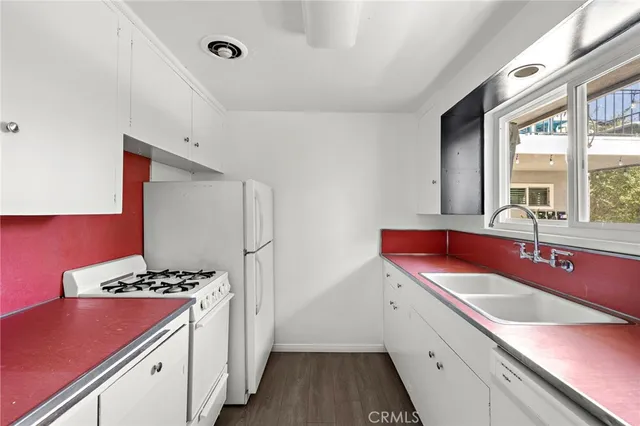 a kitchen with a sink stove and refrigerator