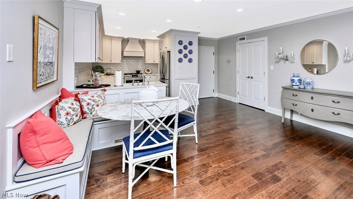 275 North Portage Path, Unit 3B Akron, OH 44303 - Photo 6 of 16 This open-concept area features rich hardwood flooring and a kitchen with white cabinetry, a tiled backsplash, and stainless steel appliances