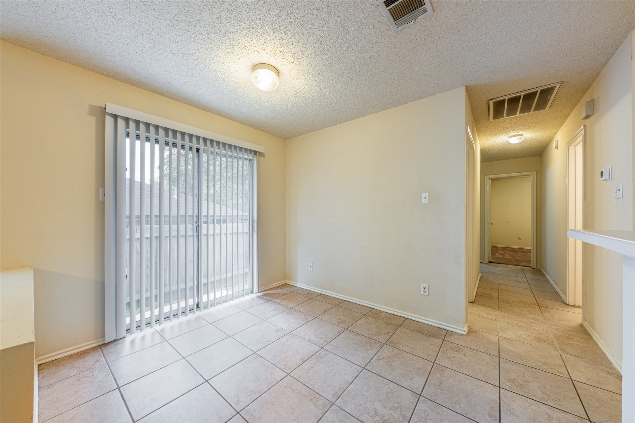7216 Aldea Drive, Unit A Austin, TX 78745 - Photo 8 of 25 Sliding glass door with vertical blinds