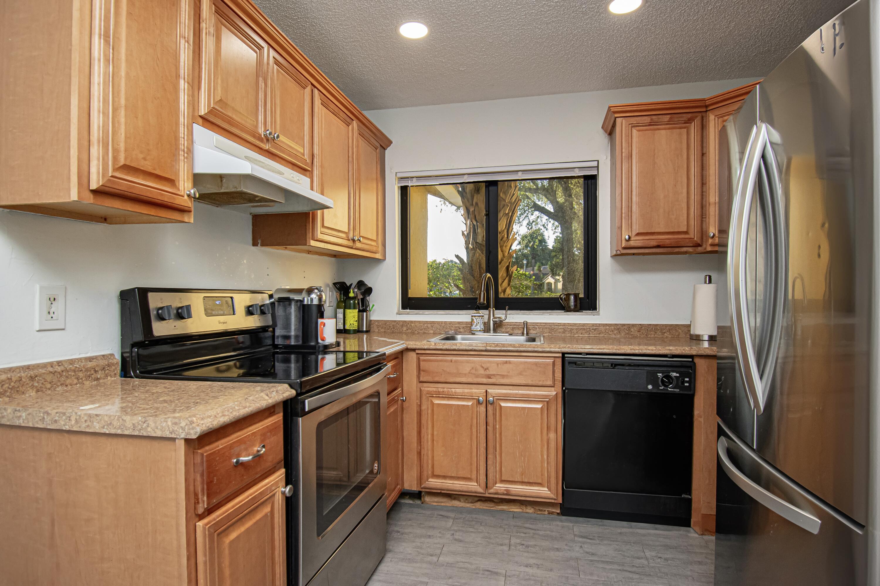 6825 Bridlewood Court Boca Raton, FL 33433 - Photo 11 of 31 a kitchen with a sink stove and refrigerator