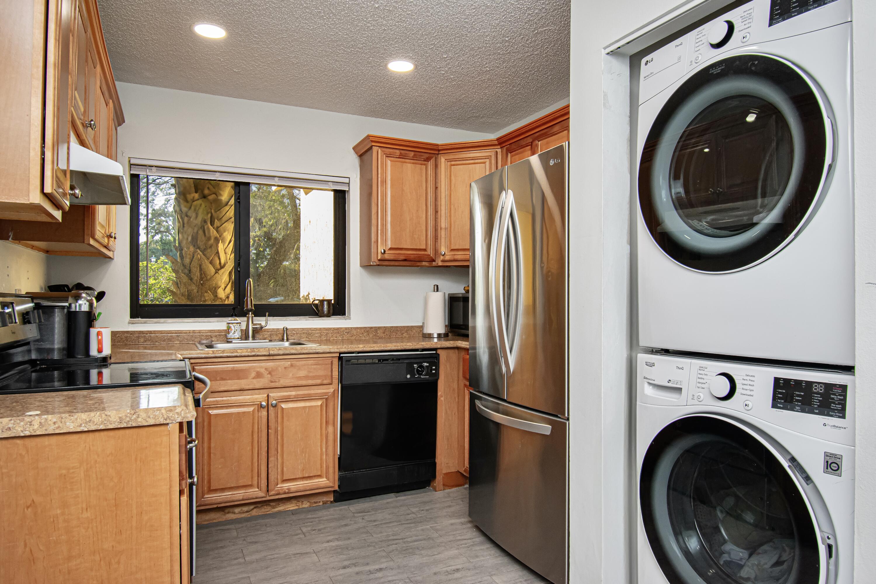 6825 Bridlewood Court Boca Raton, FL 33433 - Photo 12 of 31 a kitchen with stainless steel appliances granite countertop a sink a stove a refrigerator and cabinets