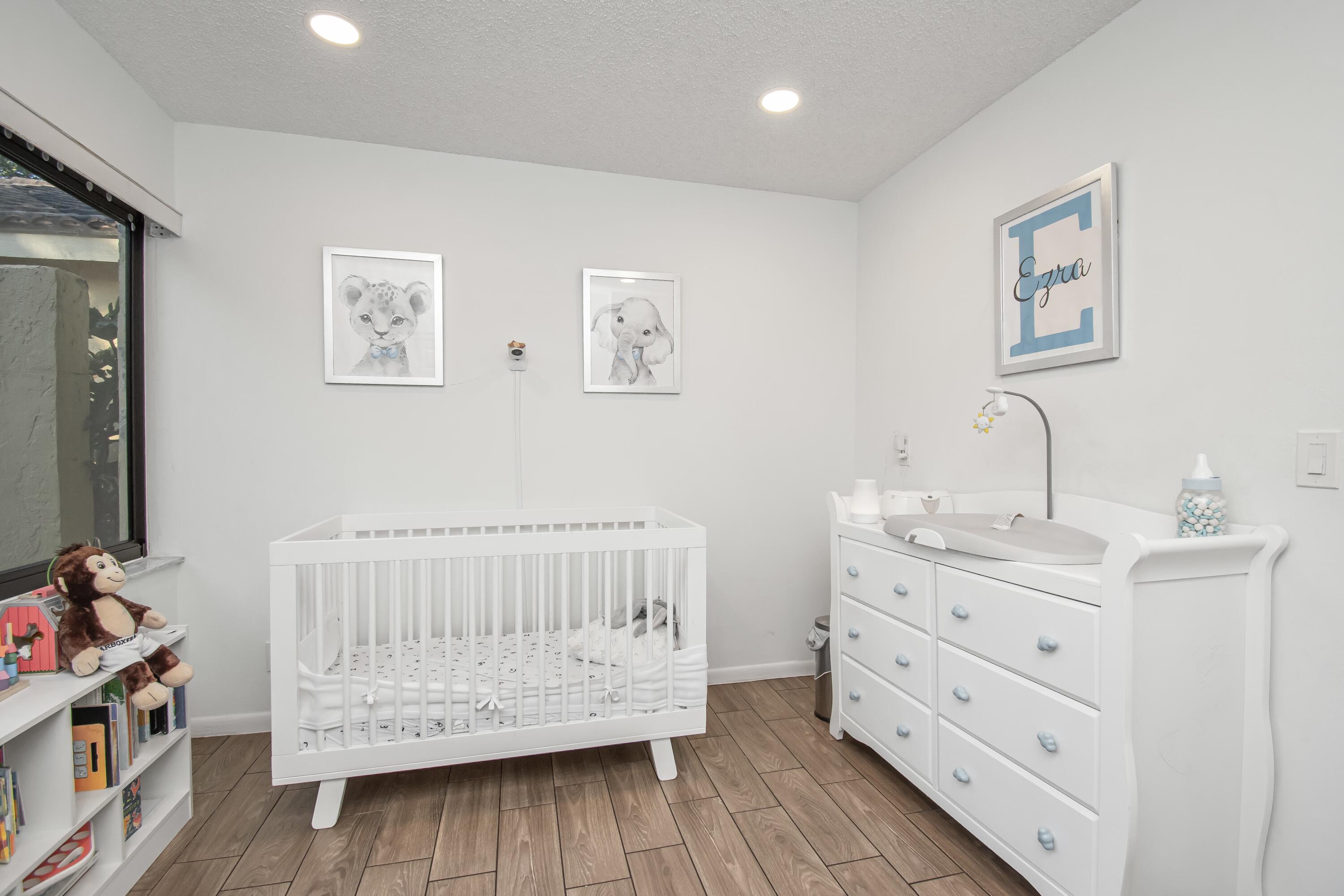 6825 Bridlewood Court Boca Raton, FL 33433 - Photo 26 of 31 a room with a baby crib dresser and a window