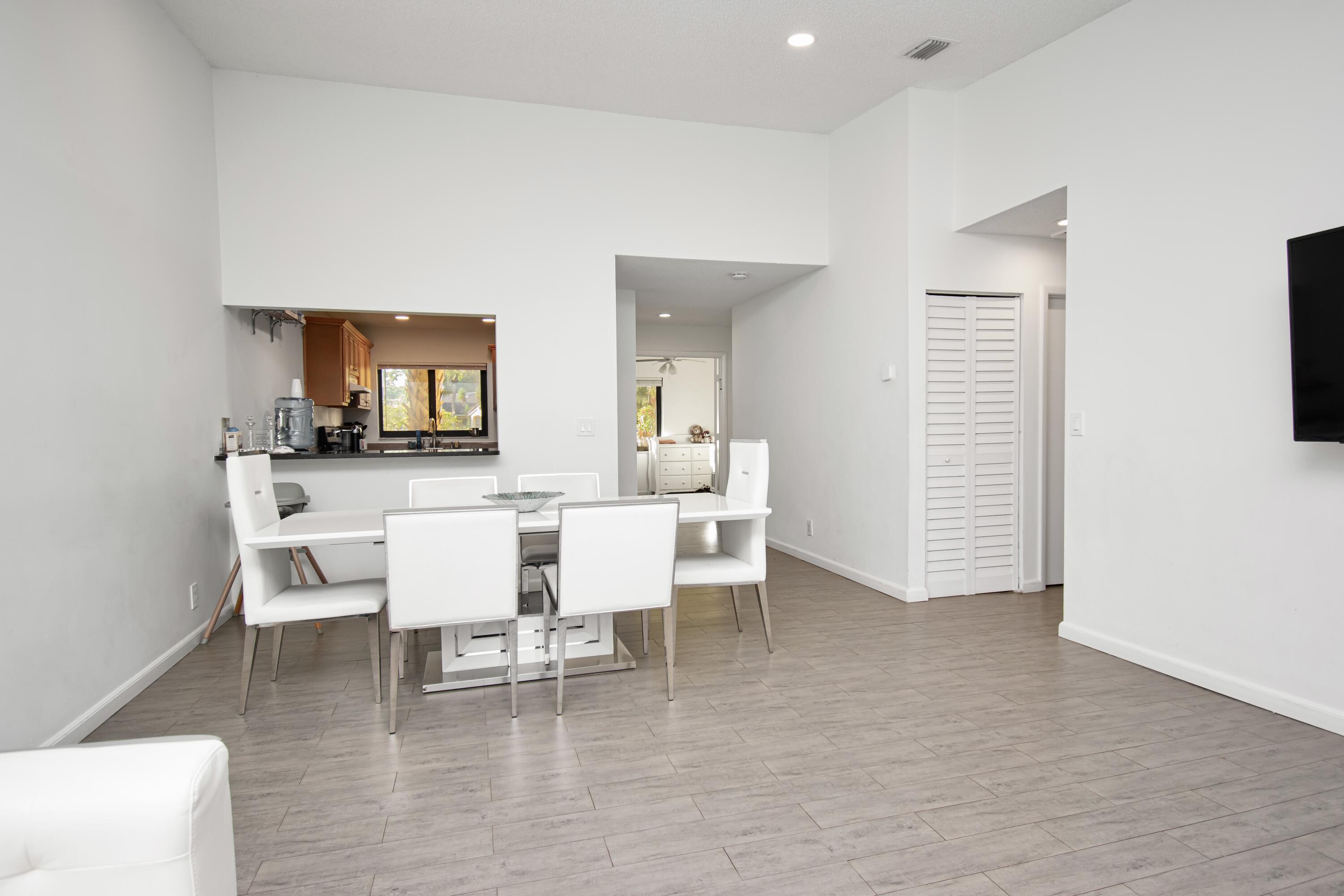 6825 Bridlewood Court Boca Raton, FL 33433 - Photo 10 of 31 a dining room with furniture and a wooden floor