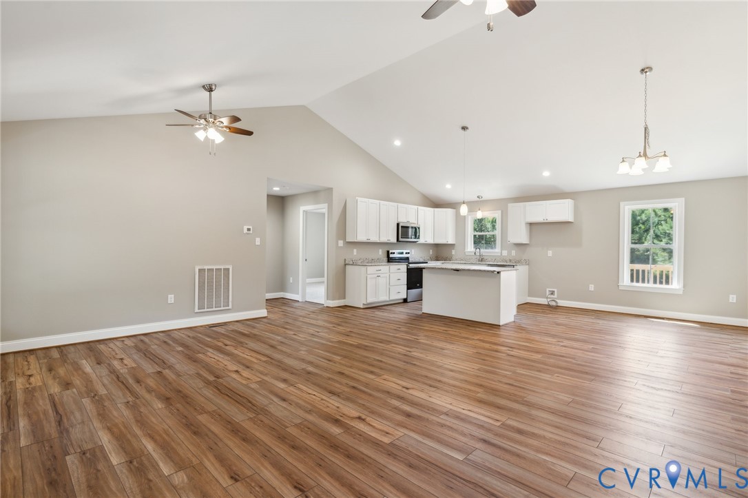527 Salem Church Road Cumberland, VA 23040 - Photo 3 of 33 a view of a kitchen with wooden floor and a kitchen space
