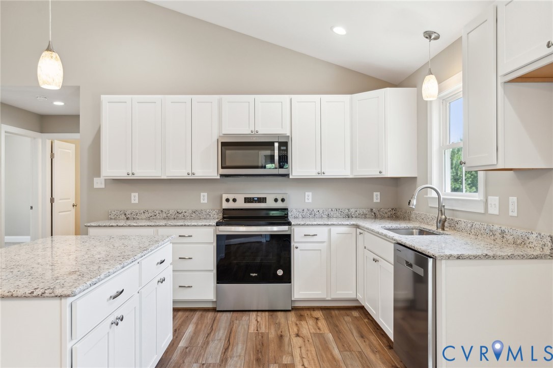527 Salem Church Road Cumberland, VA 23040 - Photo 7 of 33 a kitchen with stainless steel appliances granite countertop a stove a sink dishwasher and a microwave oven with wooden floor