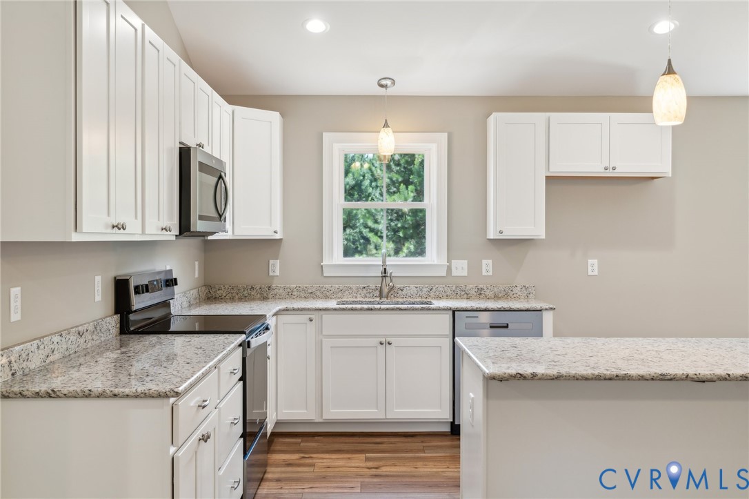 527 Salem Church Road Cumberland, VA 23040 - Photo 9 of 33 a kitchen with granite countertop a sink a stove and cabinets