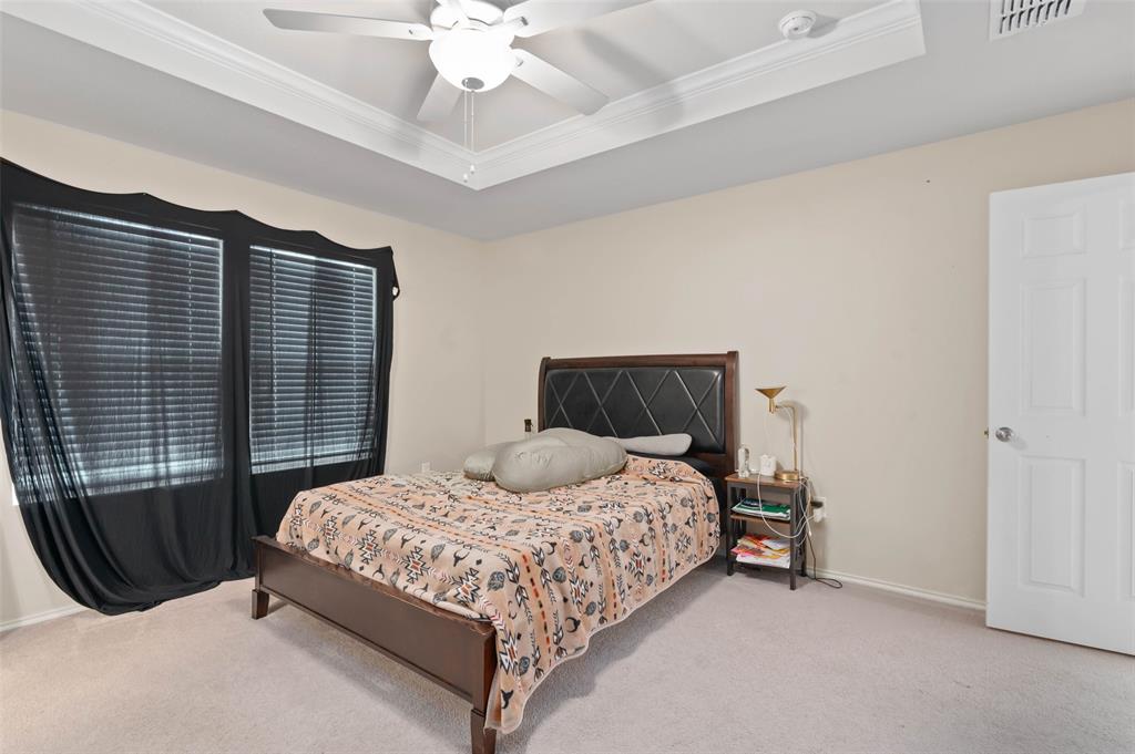 7016 Calshot Road Pilot Point, TX 76258 - Photo 14 of 28 Room featuring a tray ceiling with crown molding, a ceiling fan, light-toned walls, and carpet flooring
