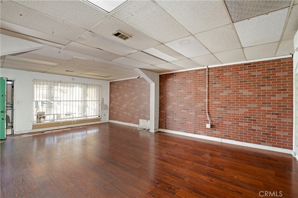 8949 Atlantic Avenue South Gate, CA 90280 - Photo 11 of 43 a view of an empty room with wooden floor and a window