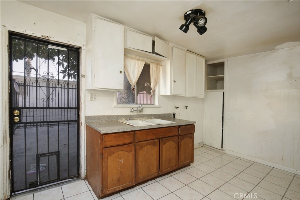 8949 Atlantic Avenue South Gate, CA 90280 - Photo 22 of 43 a kitchen with a sink cabinets and window