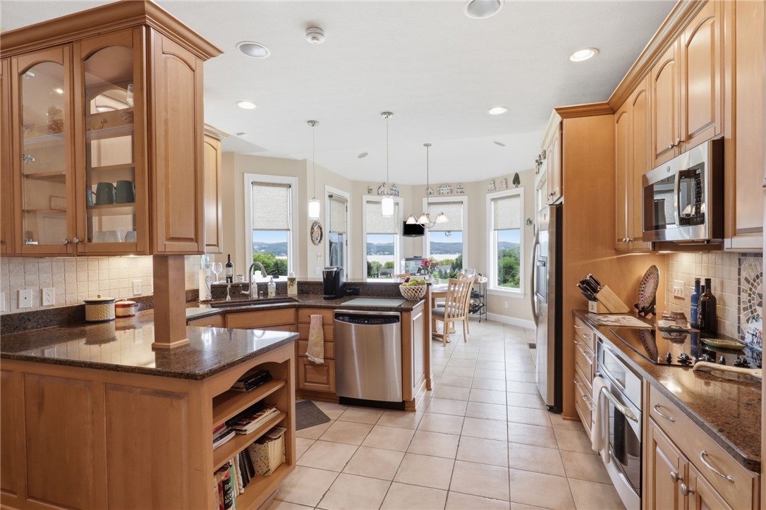 4536 Crystal Ridge Circle Gorham, NY 14424 - Photo 10 of 48 This stunning kitchen features durable ceramic tile flooring, high-end stainless steel GE Profile appliances, and a professional-grade built-in cooktop, making it a perfect space for both cooking and entertaining.