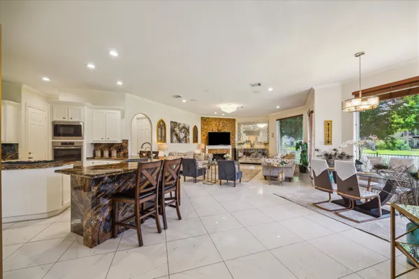 a living room with lots of furniture and kitchen view
