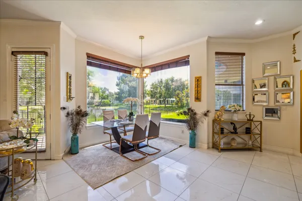a living room with furniture and large windows