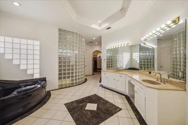 a large white kitchen with a large window