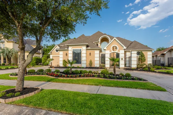 a front view of a house with a garden